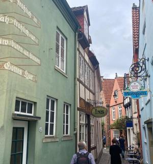 a group of people walking down a narrow street