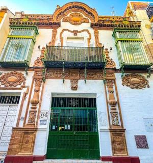 a building with green doors and a balcony