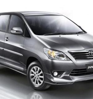 a gray minivan is shown on a white background