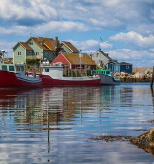 two boats are docked in the water next to houses