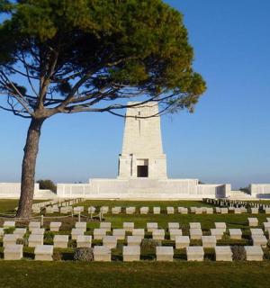 a monument with a tree in the middle of a field