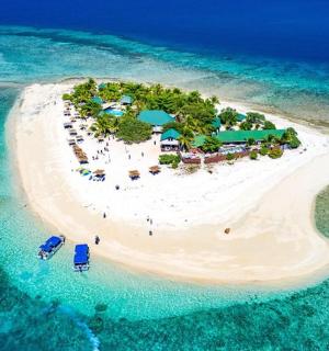an island with a resort in the middle of the ocean