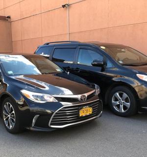 two cars parked next to each other on a street