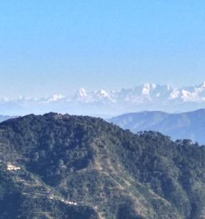 a mountain range with snow capped mountains in the distance
