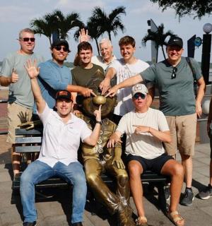 a group of men are posing for a picture