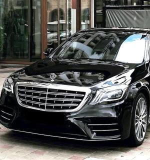 a black car parked on a city street