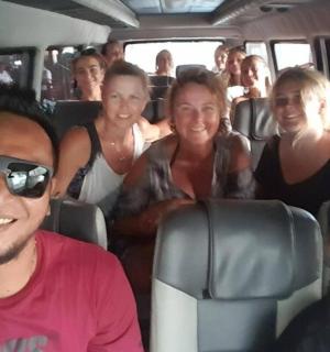 a group of people sitting in the back of a bus