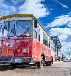 an old red and yellow bus parked on a street
