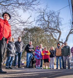a woman standing in the street with a group of people