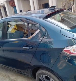 a small blue car parked in a parking lot