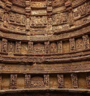 a stone building with intricate designs on the side of it