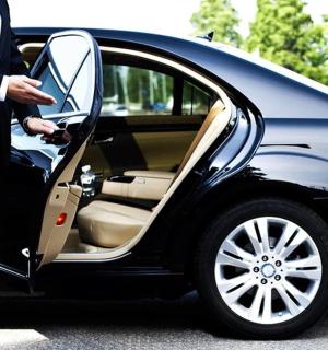 a man in a suit getting into a car
