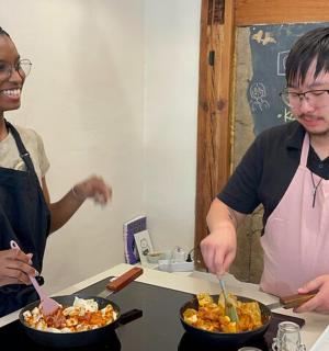 a man and a woman preparing food in a kitchen