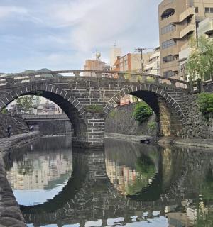 a stone bridge over a river in a city