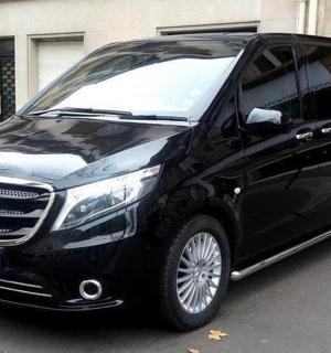 a black mercedes benz van parked on a street