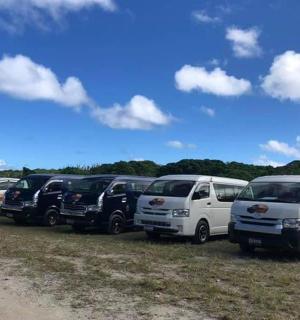 a row of parked vans parked in a field