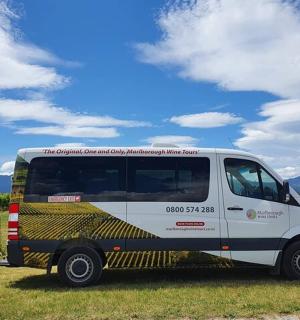 a small white van parked in a field