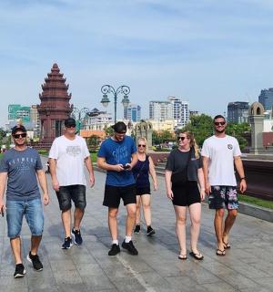 a group of people walking down a sidewalk