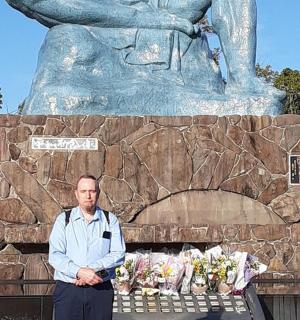 a man is standing in front of a statue
