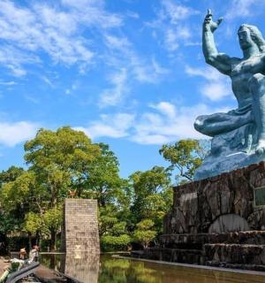 a statue of a woman with her hands in the air