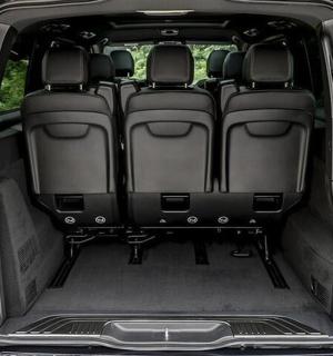 an open trunk of a car with the back doors open