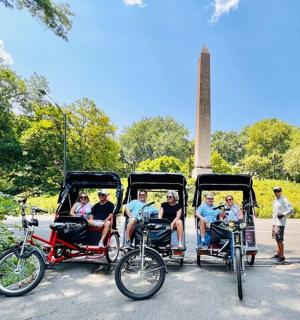 a group of people riding in a horse drawn carriage