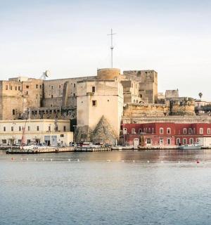a large castle sitting next to a large body of water
