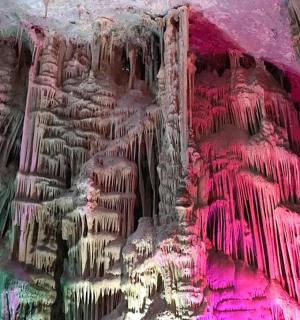a painting of a cave with pink and green paint