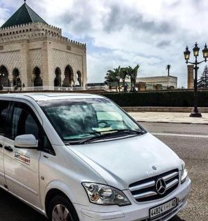 a white van parked in front of a building