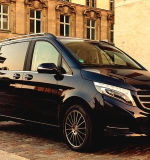 a black car parked on a brick street