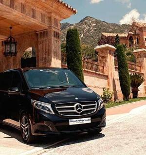 a black car parked in front of a house