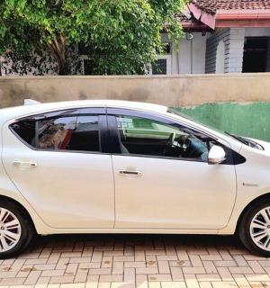 a white car parked on a brick road