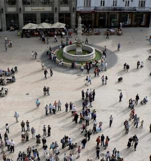 a large group of people standing around a fountain