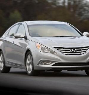 a silver car is driving down a road