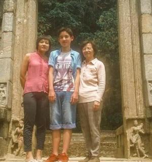 three people standing in front of a building