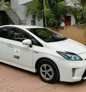 a white car parked in front of a house