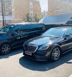 two cars parked next to each other in a parking lot