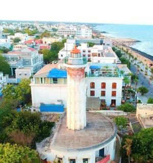 an aerial view of a city with a lighthouse