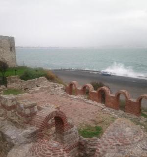a train is on a road next to the ocean
