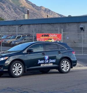 a blue car parked on the side of a street