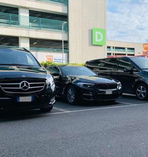 three cars parked in a parking lot in front of a building