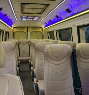 an empty train car with white seats and purple lights