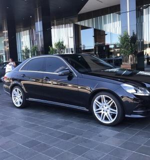 a black car parked in front of a building