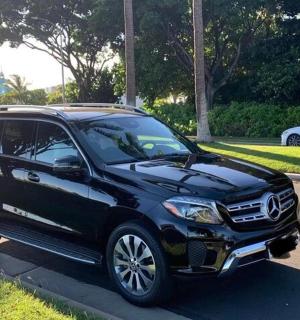 a black suv parked on the side of a road