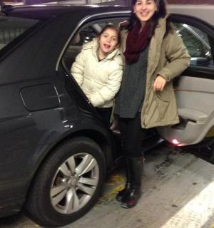 a woman and child sitting in a car