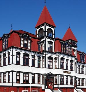 a large red and white building with a tower