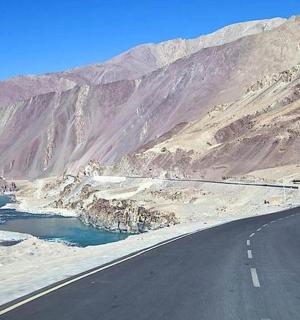 en vej midt i et bjerg med en flod