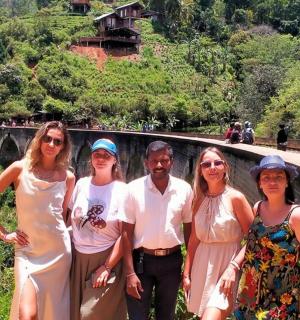 a group of people posing for a picture on a bridge