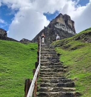 a man walking up a set of stairs on a hill