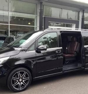 a black van parked in front of a building